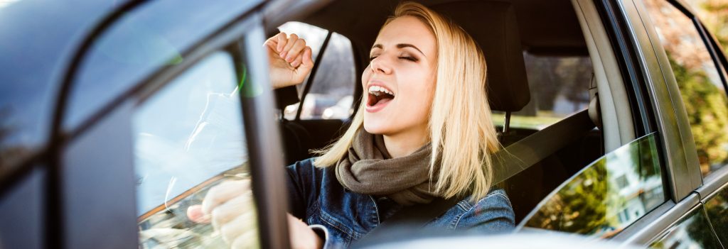 Lady in her car singing to the radio