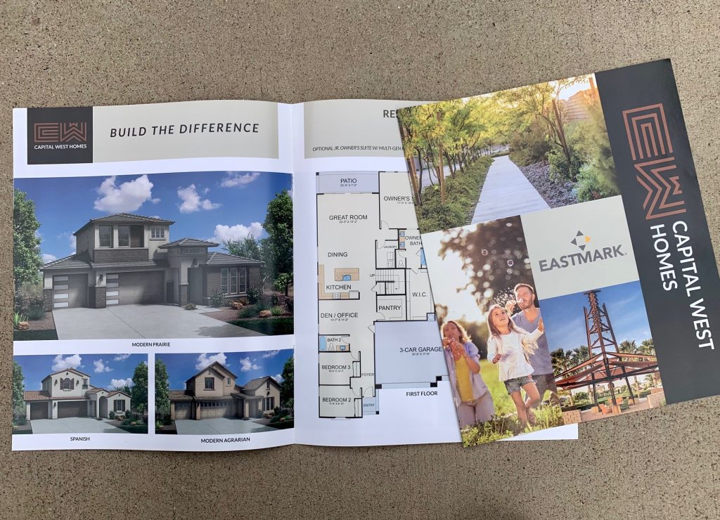 A print brochure for Capital West Homes in Arizona featuring a cover with photos of a family, community landscape, and house renderings and floor plans inside.