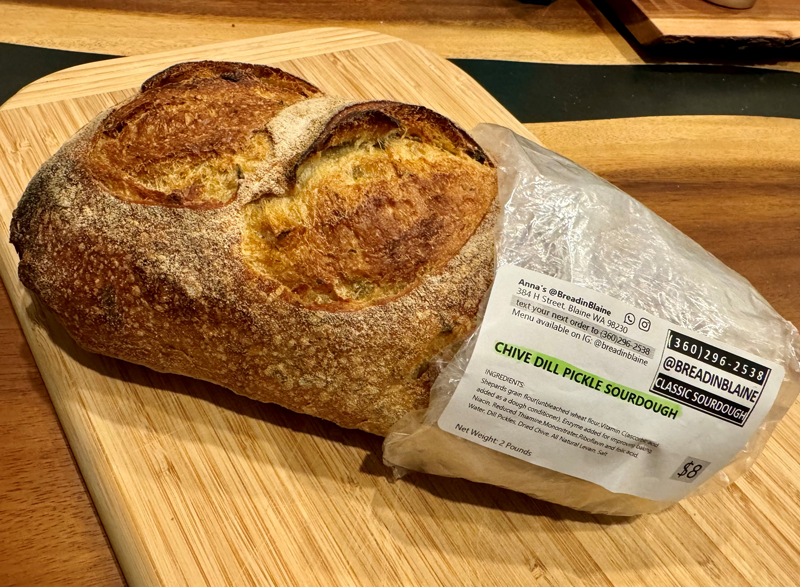 a loaf of chive dill pickle sourdough bread
