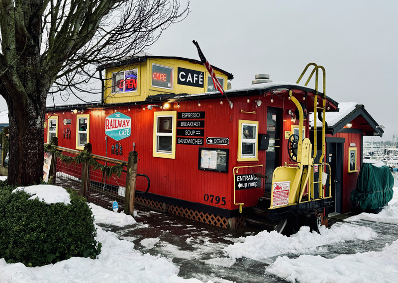 a caboose in snow hosing the Railway Cafe