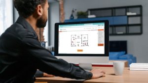 Man looking at interactive floor plan with multiple home builder browser tabs open