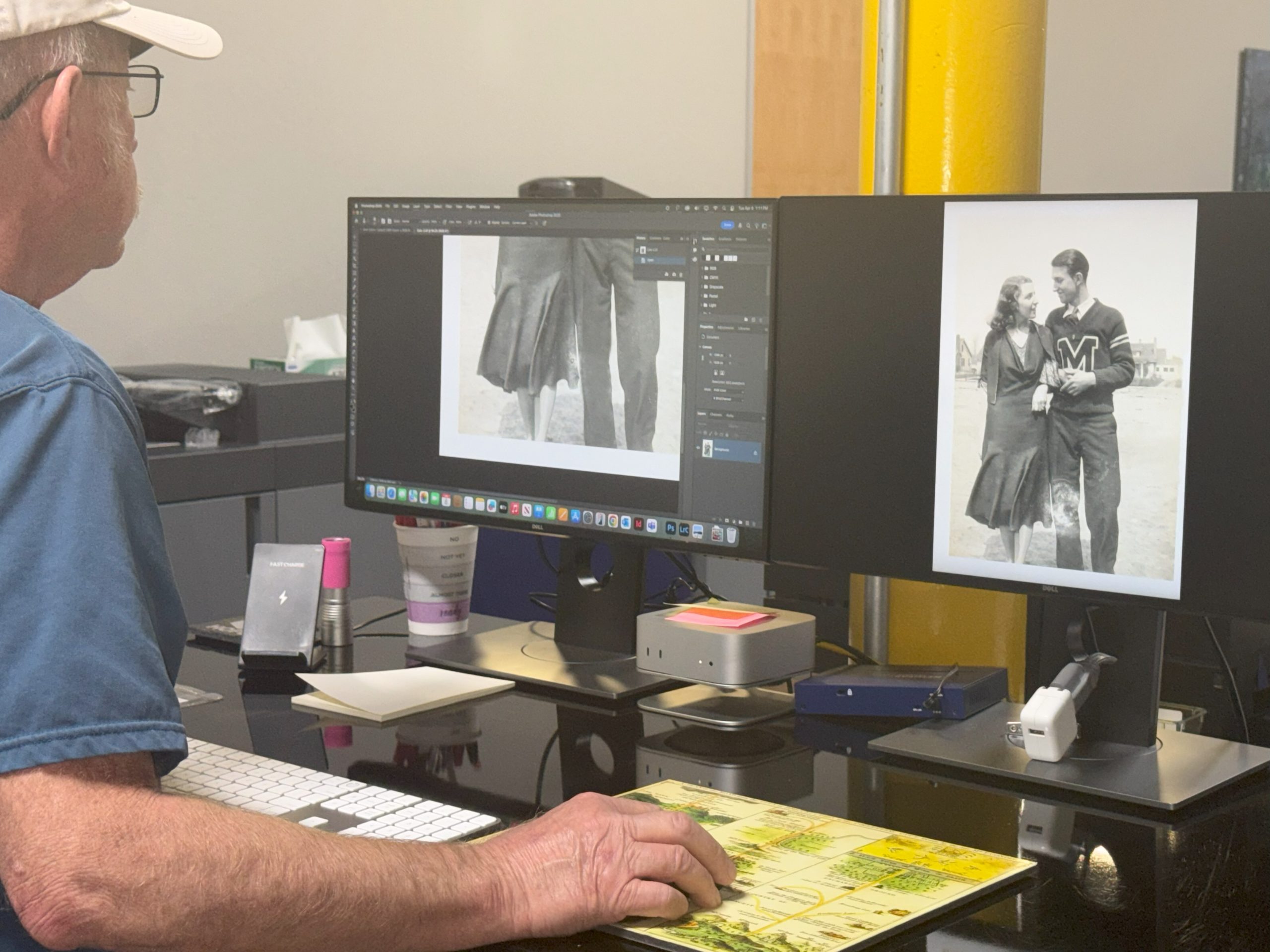 man at computer touching up a vintage photo.