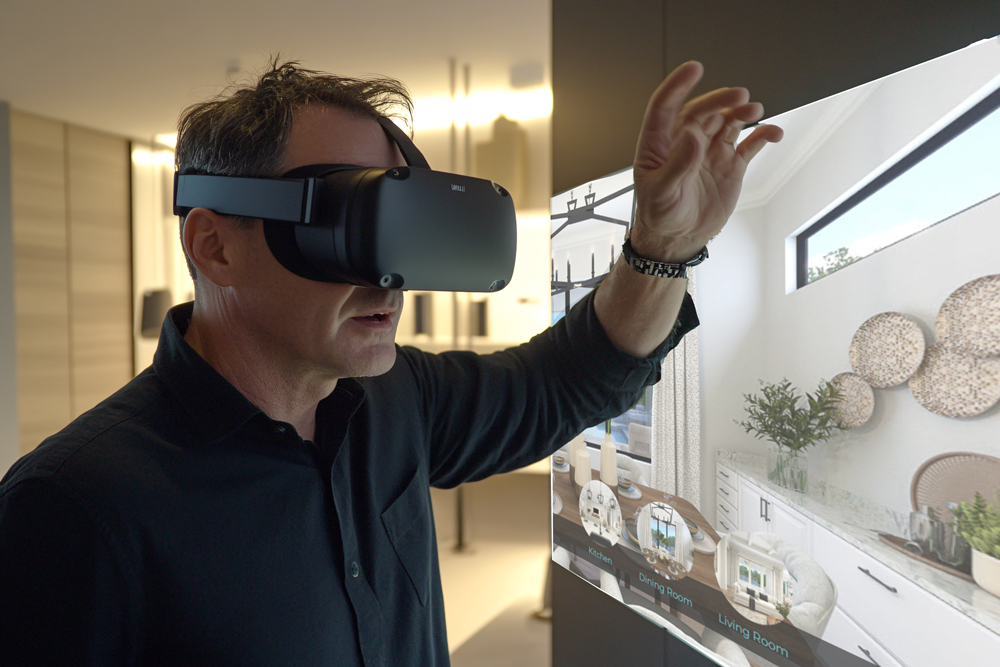 Buyer using VR headset in sales office to take home tour.
